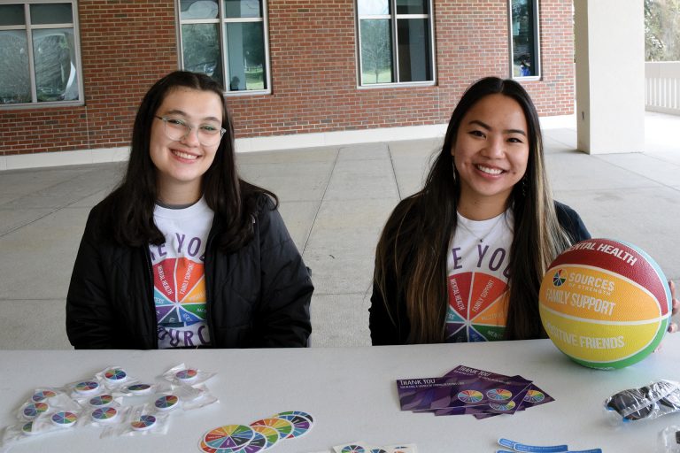 Mailys Angibaud and Delaney Phelps promote mental wellness at a tabling event in front of the Reitz Union on campus. Photo by Lauren Barnett.